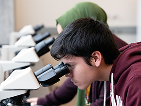 Experience Central students looking through a microscope.