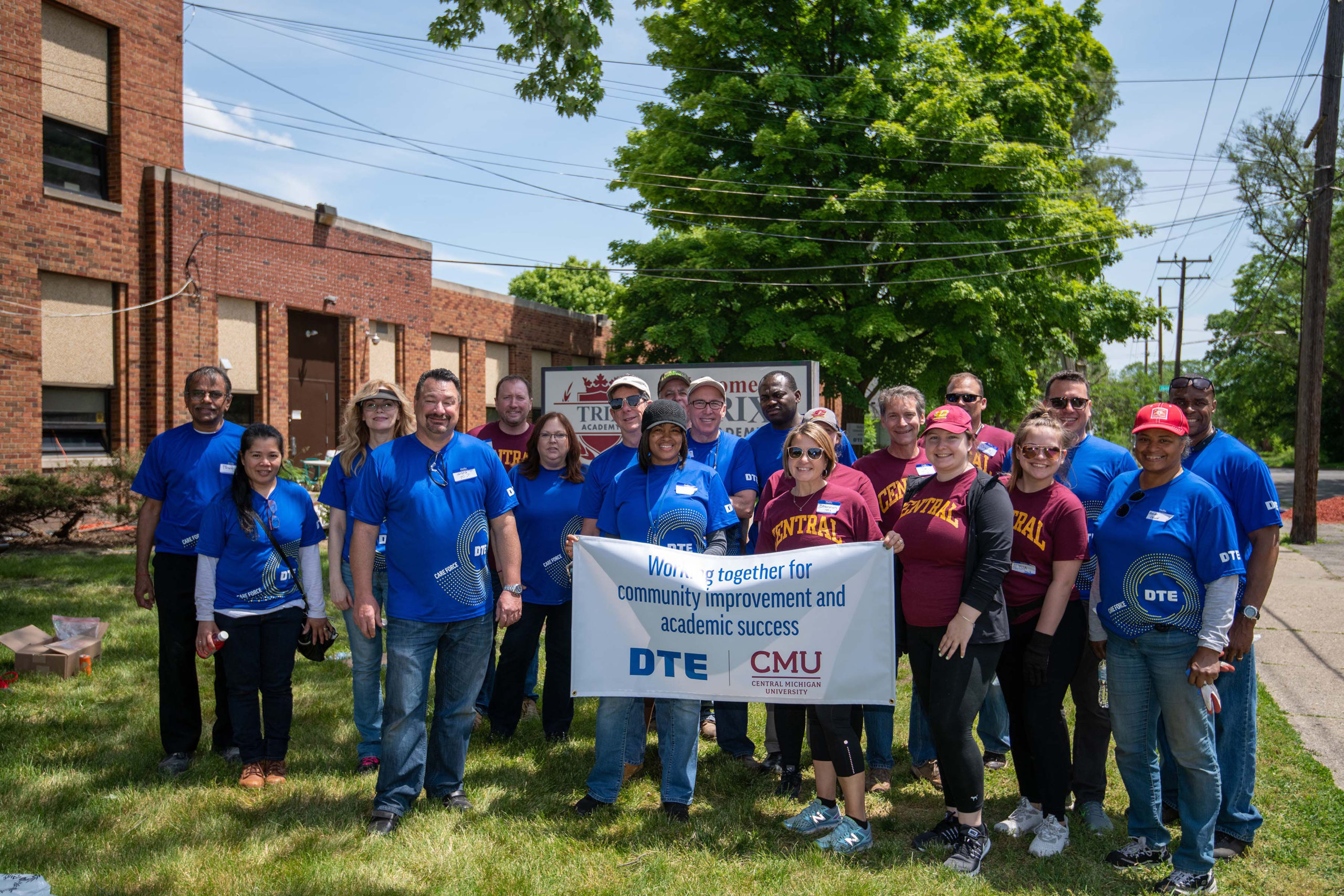 Volunteers from DTE Energy' Major Enterprise Projects (MEP) and CMU (Central Michigan University) work on installing new landscape at Trix Academy inn Detroit.