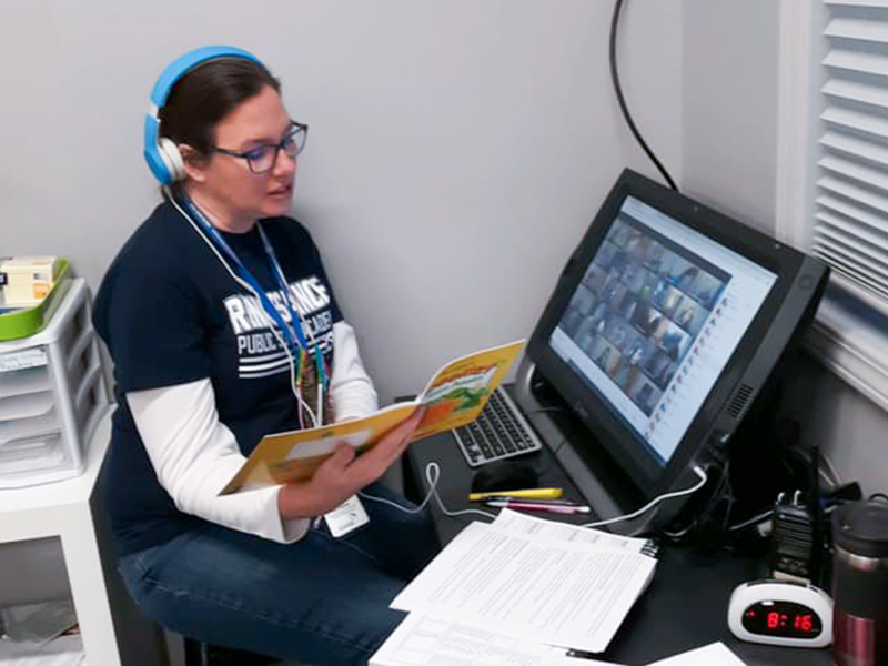 Teacher from Renaissance Public School Academy reading to students during a virtual lesson.