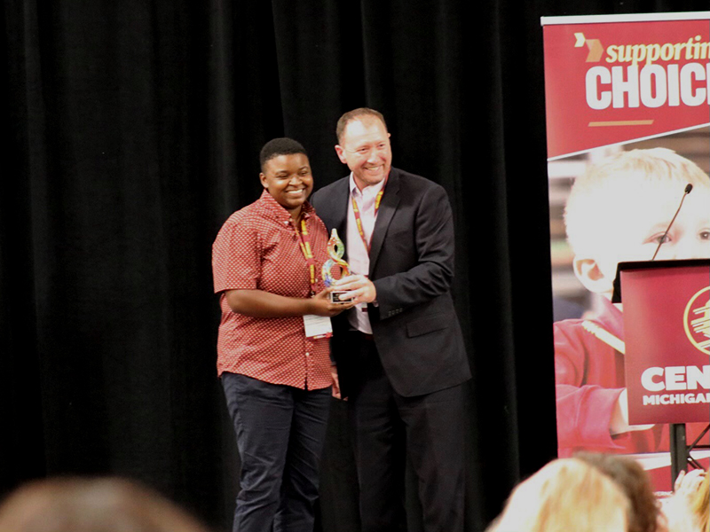 The center's executive director poses next to Countryside Academy's presenter, holding the Innovation and Vision award.