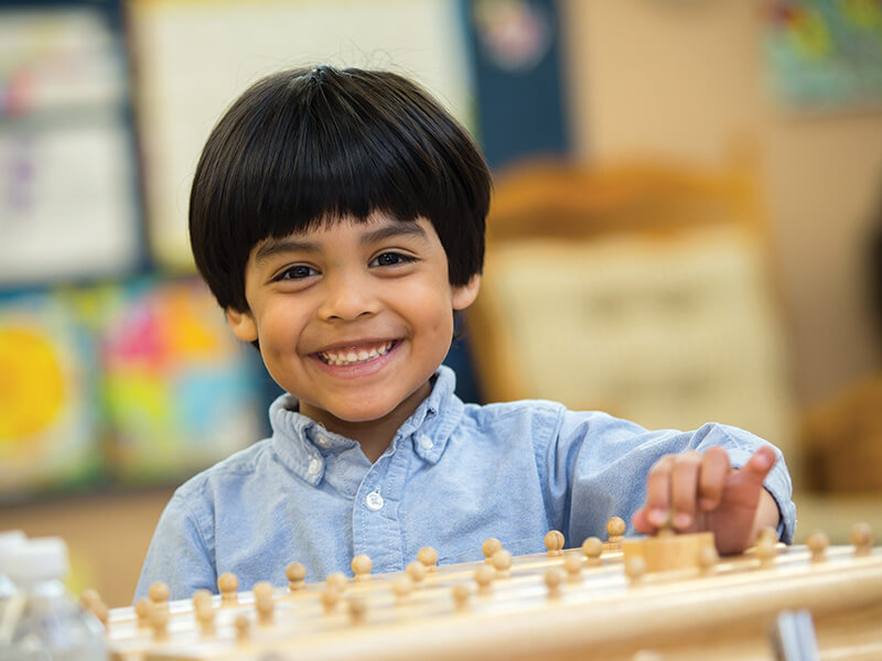 Young student smiling at the camera.