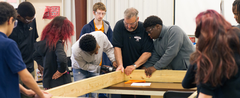 Students and teacher at Countryside Academy constructing a woodworking project. 