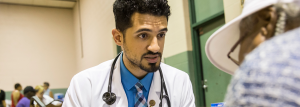 Firas Shalabi consulting with a patient at the Flint Health Fair