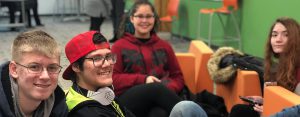 Four students from NexTech High School of Lansing smiling at the camera.