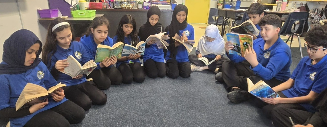 Group of students reading books.